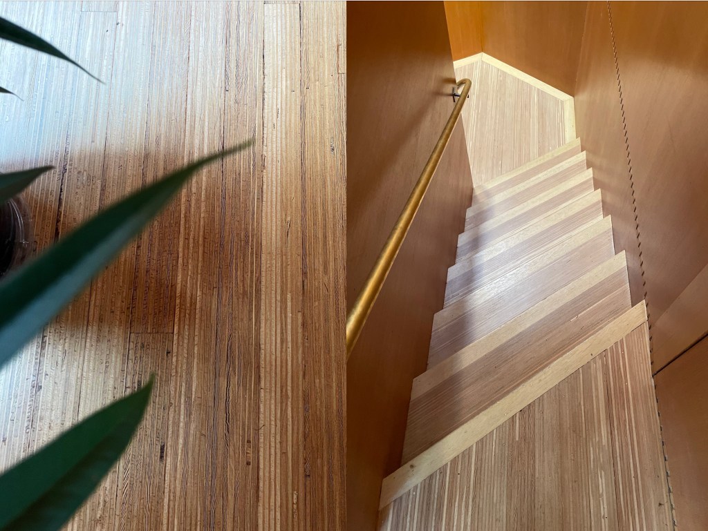 Pinstriped hardwood floors cover the entire second floor and angled staircase. Photos taken by Christina Rinaldi, 2024.